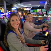 Two alumni smiling after playing Mario Kart